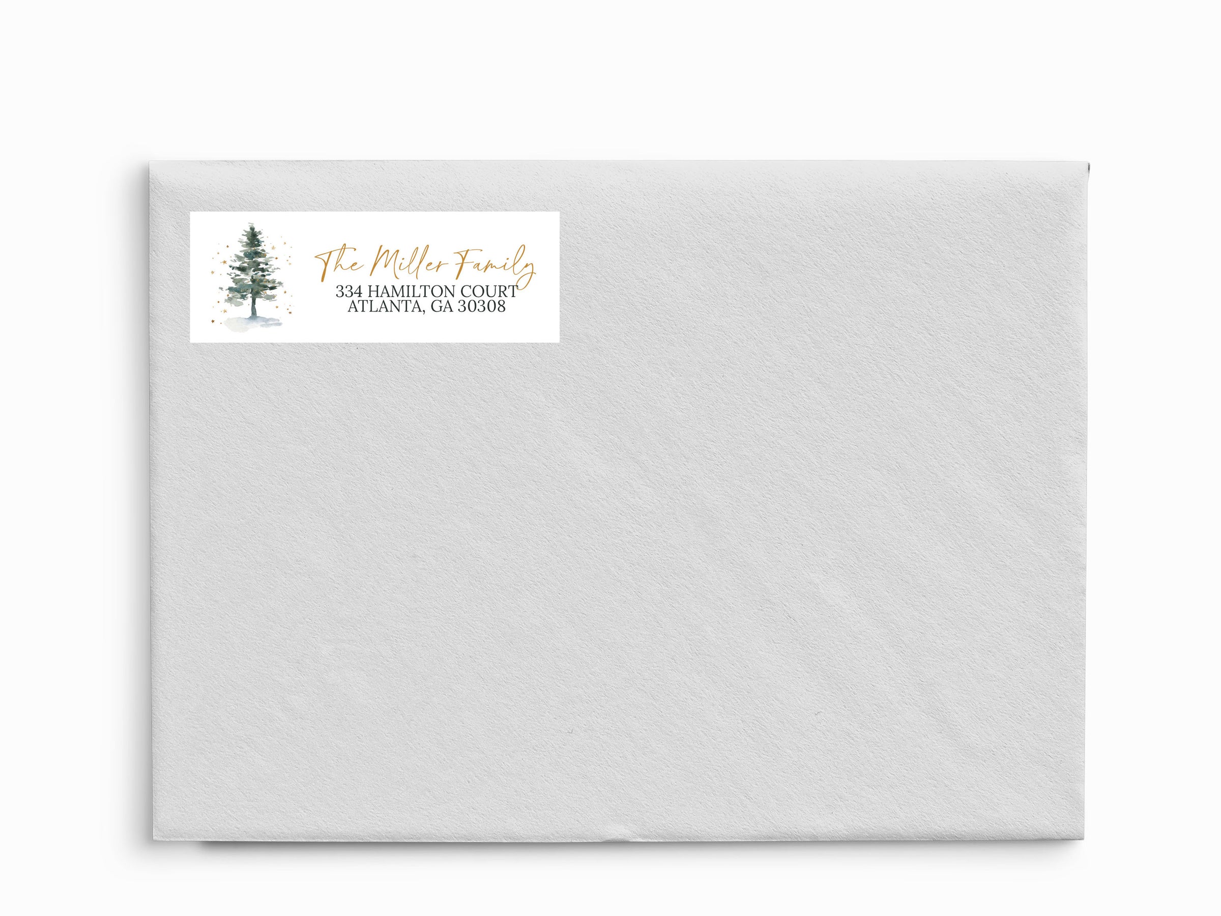 White envelope with a return address label featuring a tree design on a white background