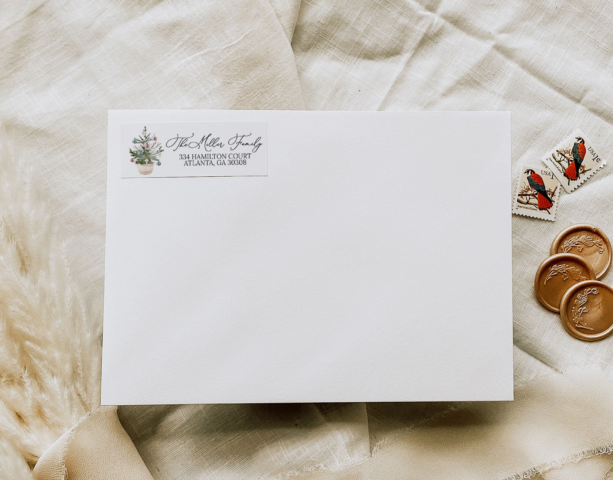 White envelope with personalized address on a textured beige surface