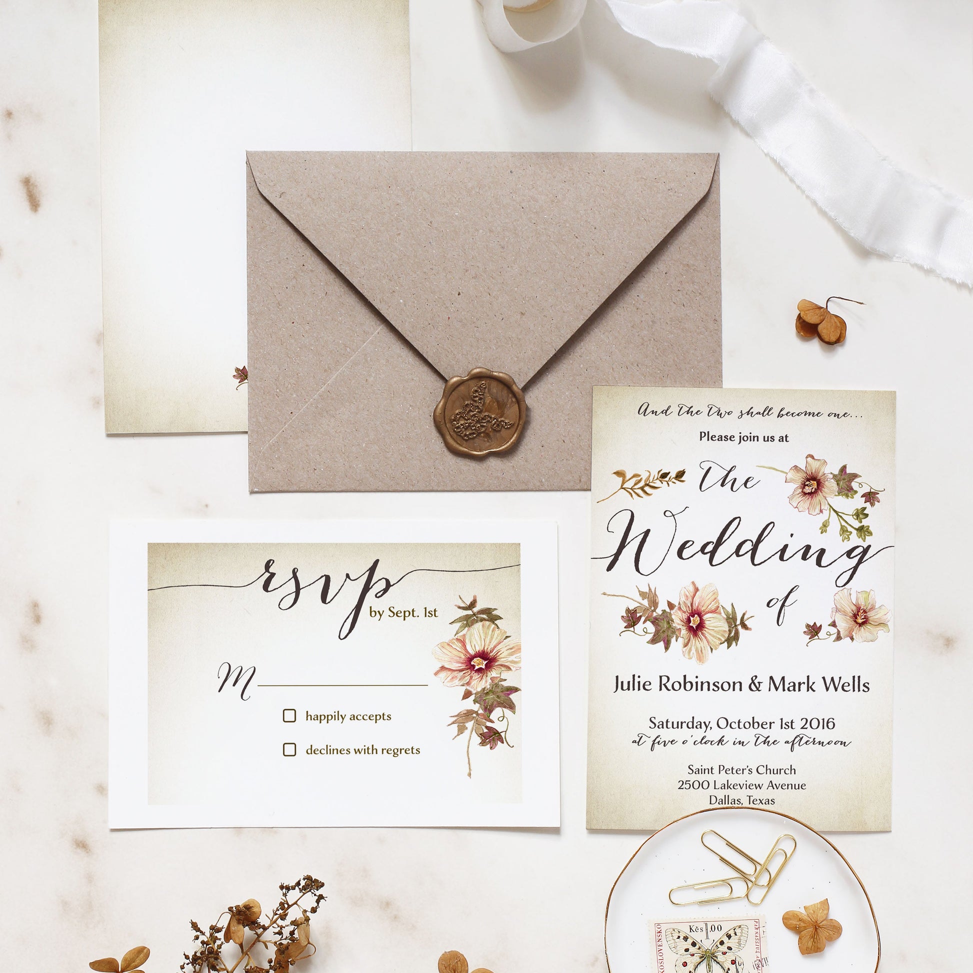 Wedding invitation set with envelope, RSVP card, and decorative elements on a light background