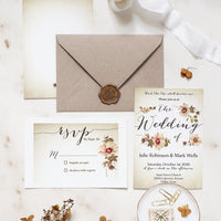 Wedding invitation set with envelope, RSVP card, and decorative elements on a light background