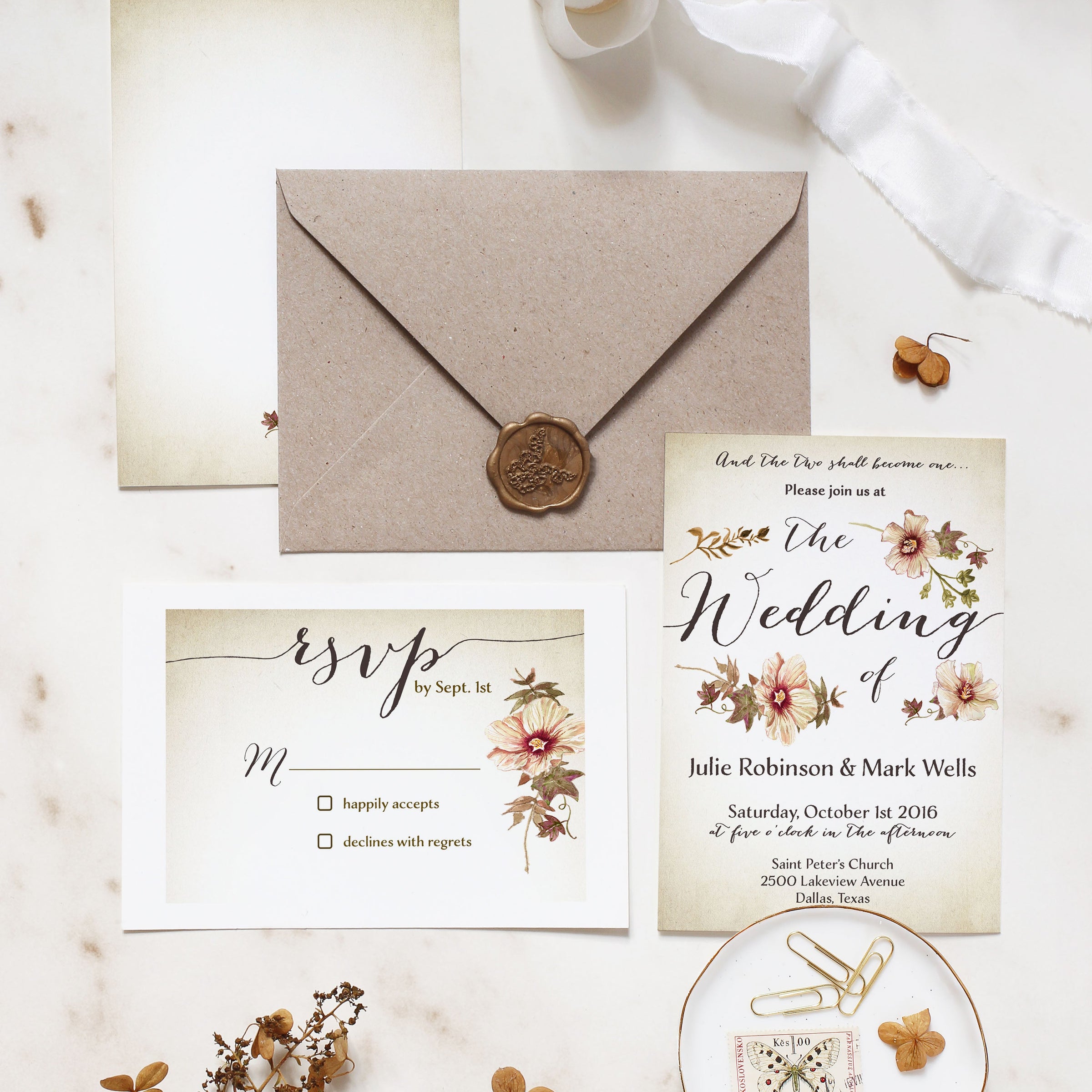 Wedding invitation set with envelope, RSVP card, and decorative elements on a light background