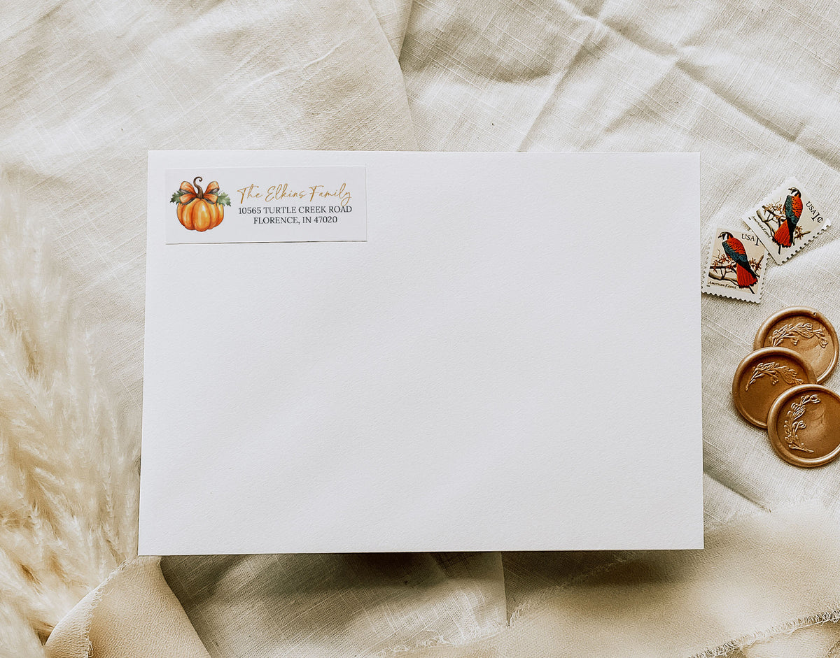White envelope with address label on a textured beige surface