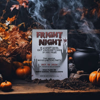 A Halloween invitation card reading 'Fright Night' is displayed on a rustic wooden table surrounded by autumn leaves, pumpkins, a cauldron, and smoke effects.