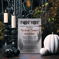 A Halloween-themed party invitation card styled on a rustic table with lit candles, pumpkins, and spooky decorations. The card reads 'Fright Night' and includes event details for 'The Annual Thompson Costume Party' in Phoenix, Arizona.