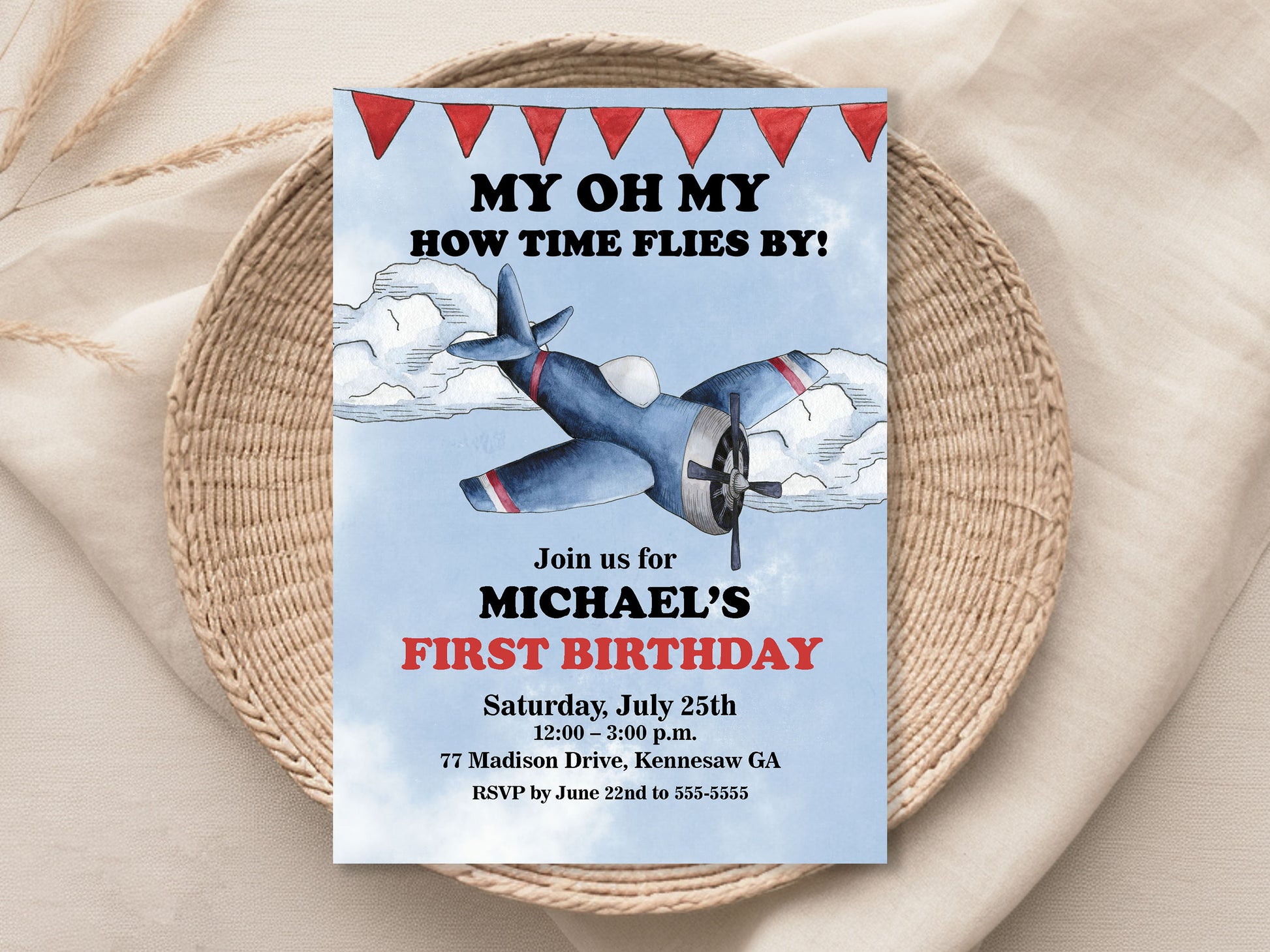 Birthday invitation card with airplane design on a woven mat