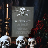 A Halloween party invitation card featuring a skull and crossbones design on a dark textured background, styled with three white skulls, red roses, and lit candles on a dark draped backdrop.