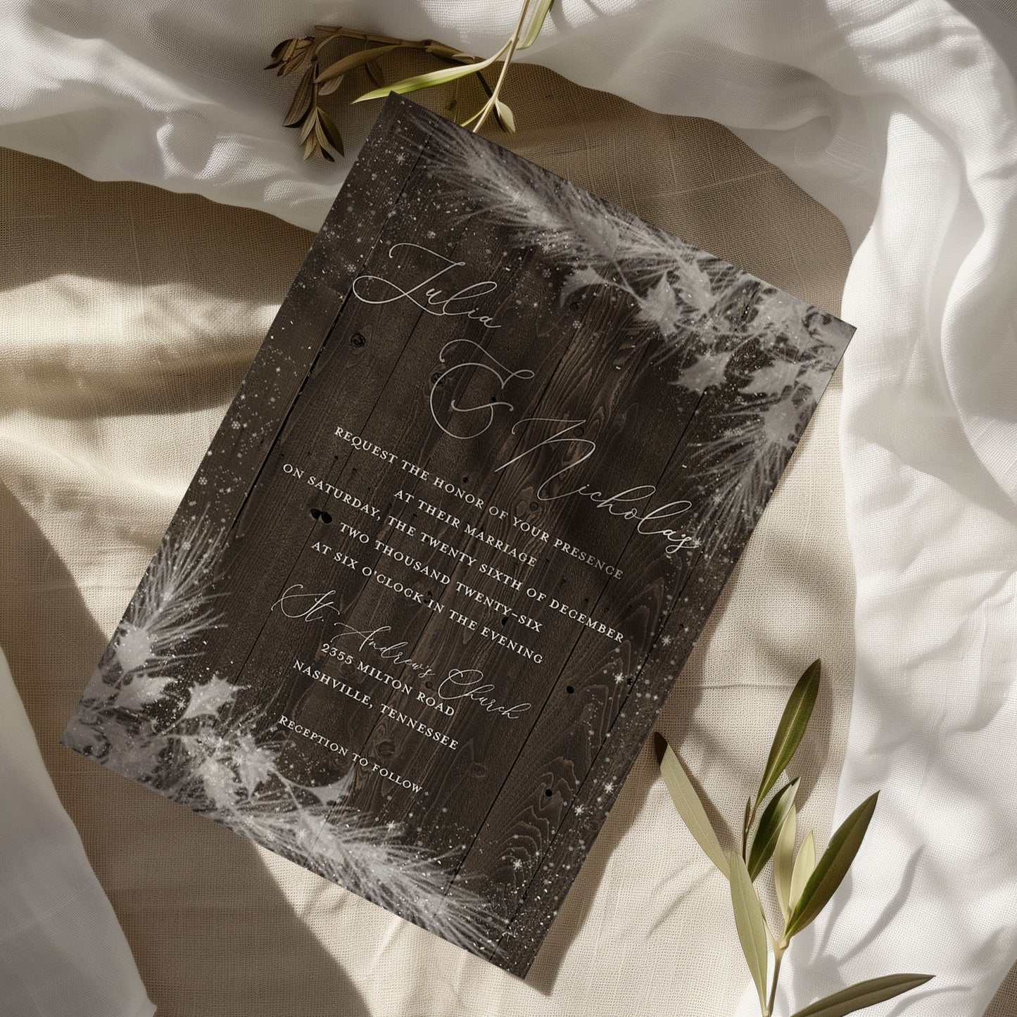 Wedding invitation card with floral design on a soft fabric background