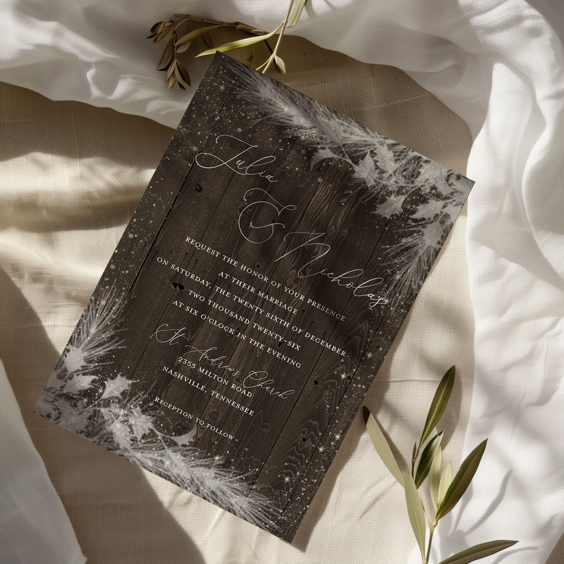 Wedding invitation card with floral design on a soft fabric background