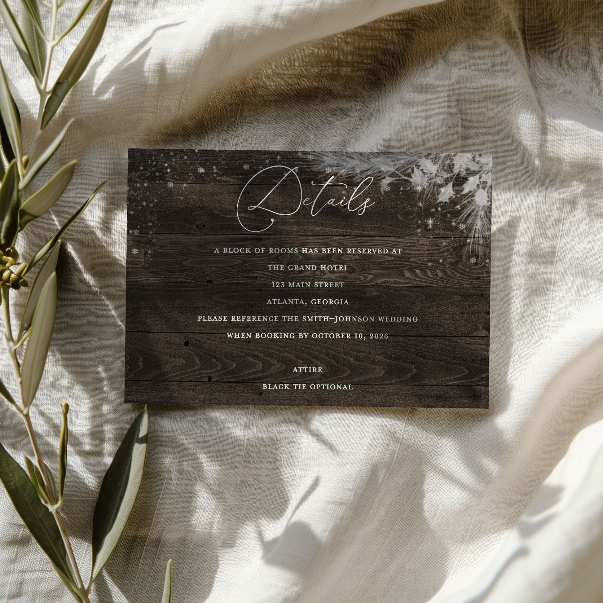 Wooden-style invitation card with text on a light fabric background