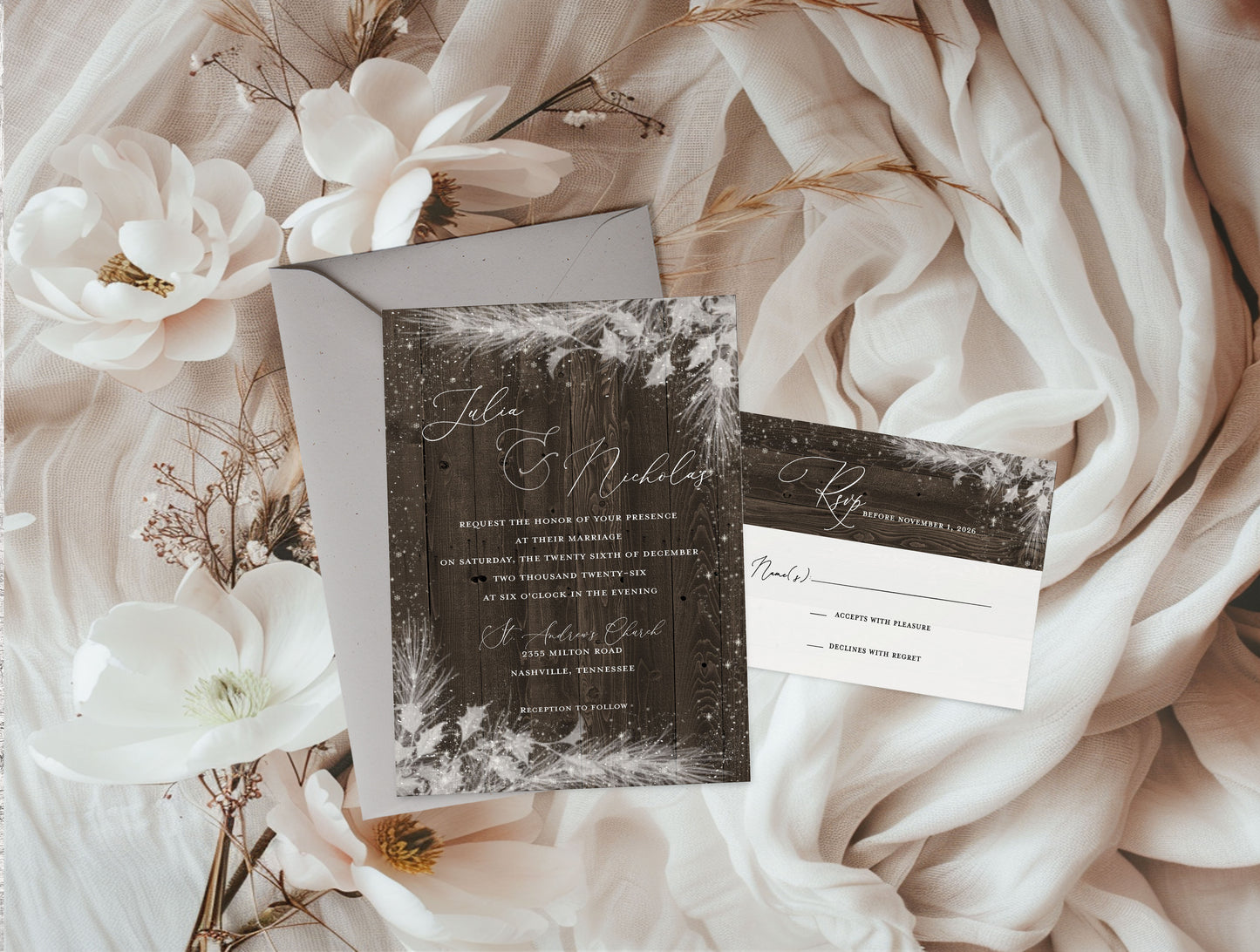 Wedding invitation set with floral decorations on a soft fabric background