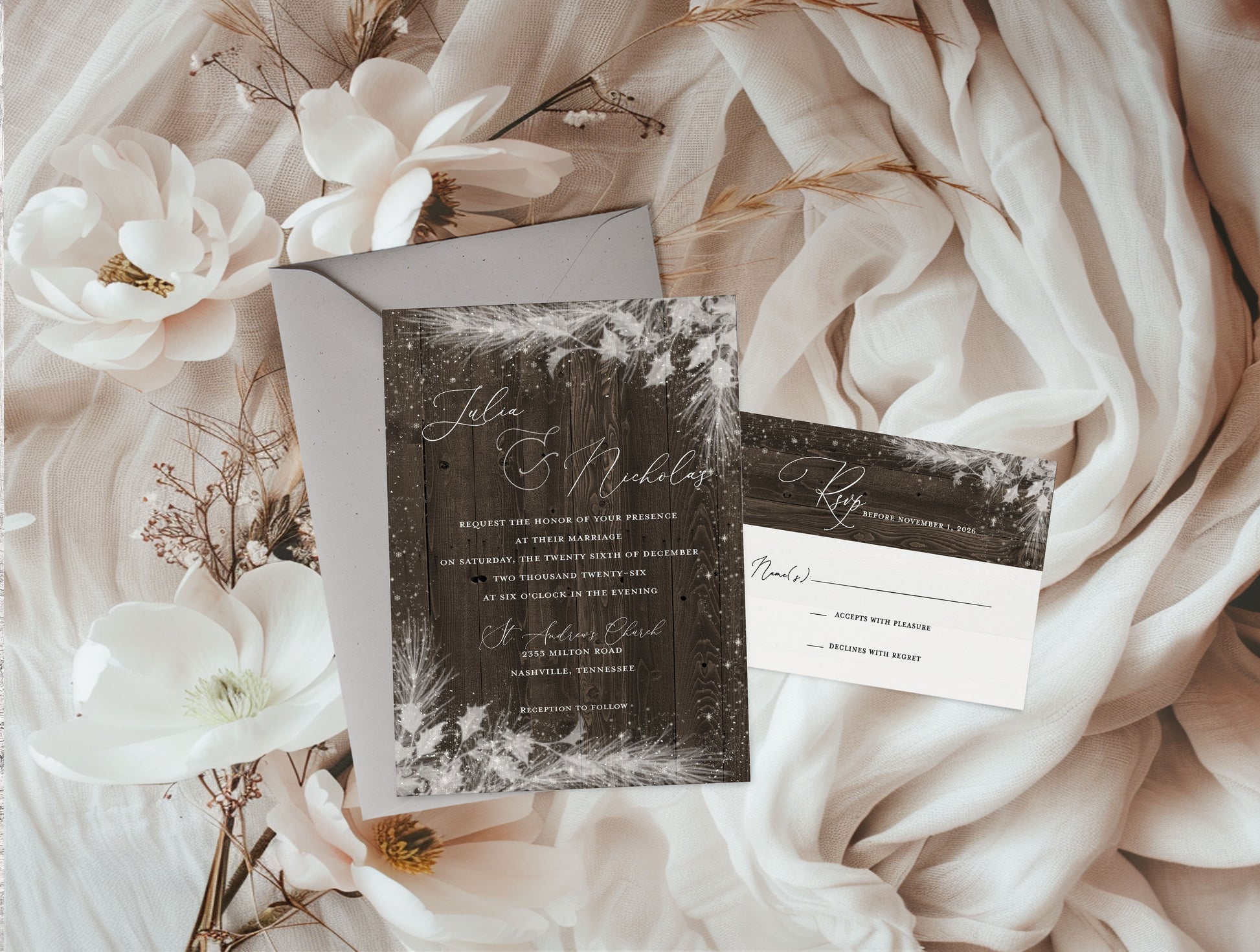 Wedding invitation set with floral decorations on a soft fabric background