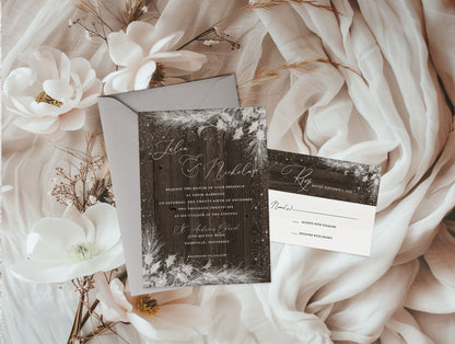 Wedding invitation set with floral decorations on a soft fabric background